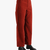 Red pants worn by a person, showing the pant's fit