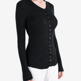 Black knitwear worn by a person, showing the knitwear fit