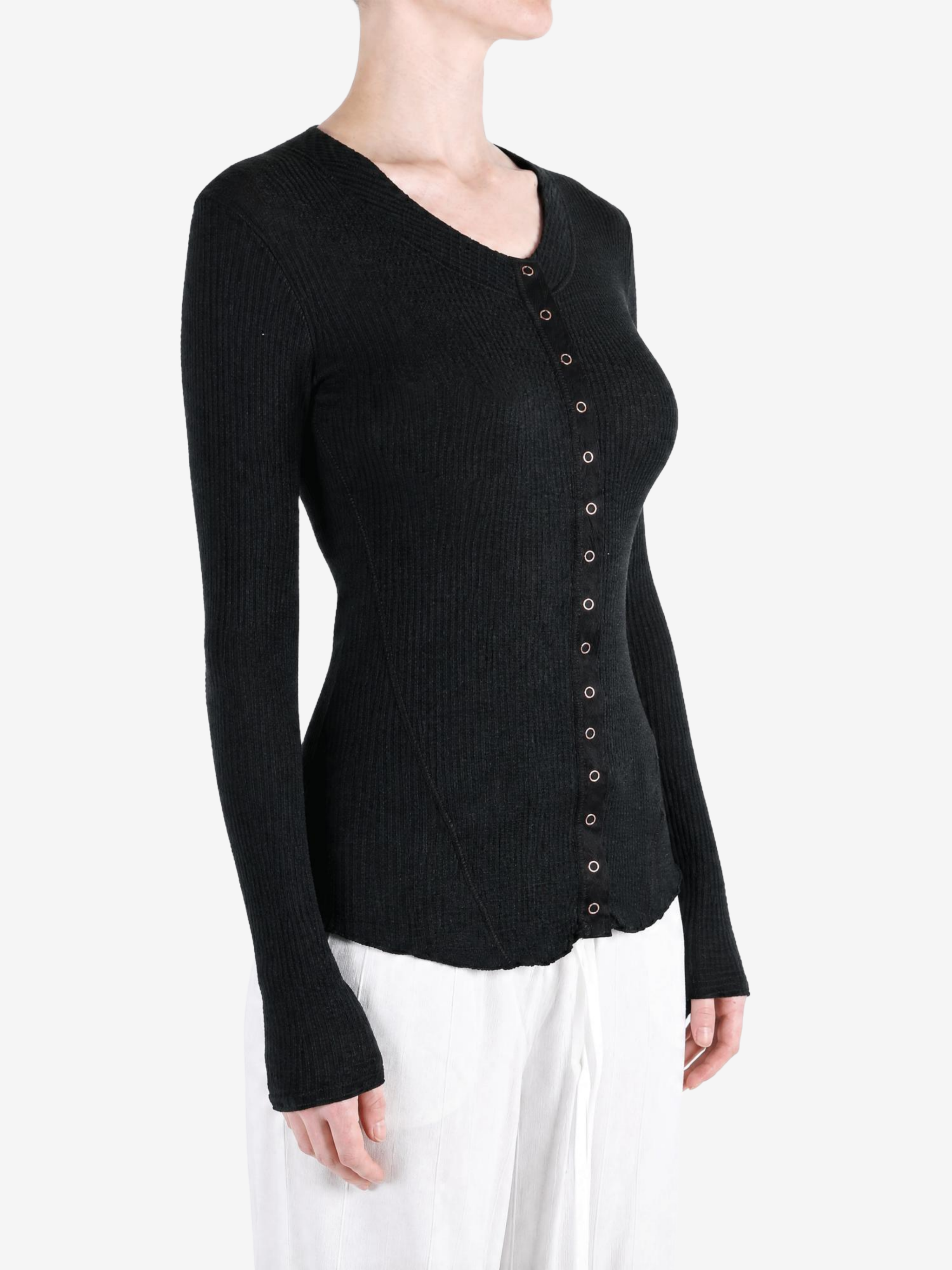 Black knitwear worn by a person, showing the knitwear fit