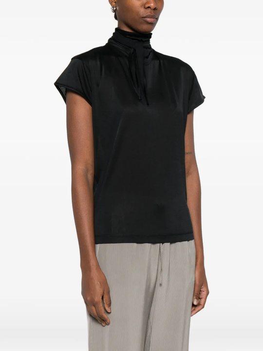 Black top worn by a person, showing the top's fit