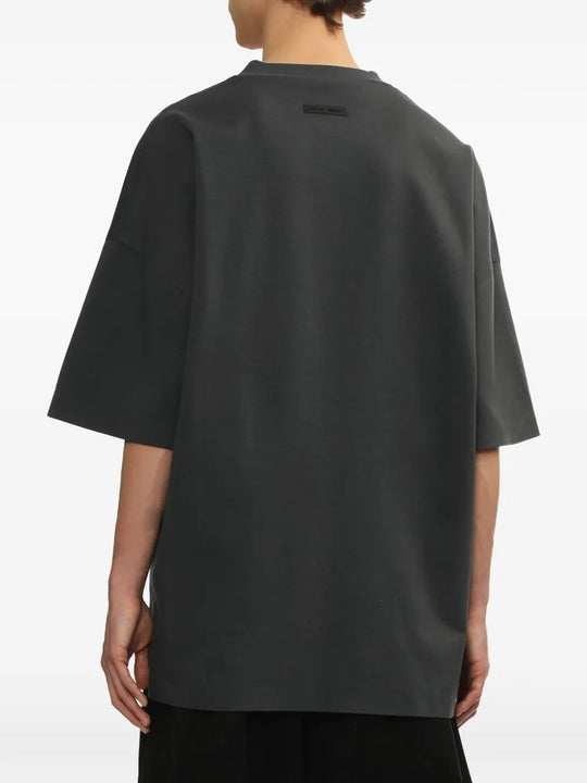 Grey t-shirt worn by a person, showing the shirt's fit