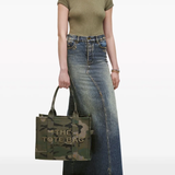 Green bag, worn by a person, showing the bag's fit