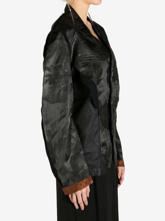 Black jacket worn by a person, showing the jacket's fit