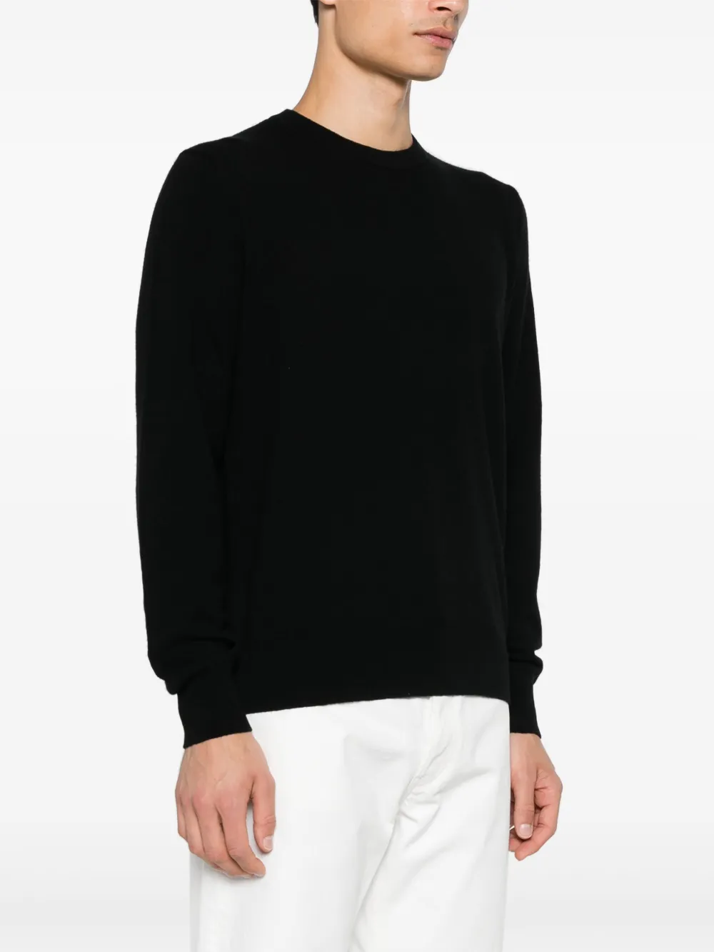Black sweater worn by a person, showing the sweater fit