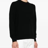 Black sweater worn by a person, showing the sweater fit