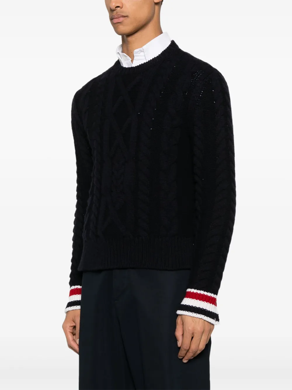 Navy knitwear worn by a person, showing the knitwear fit