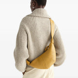 Tan bag worn by a person, showing the bag fit