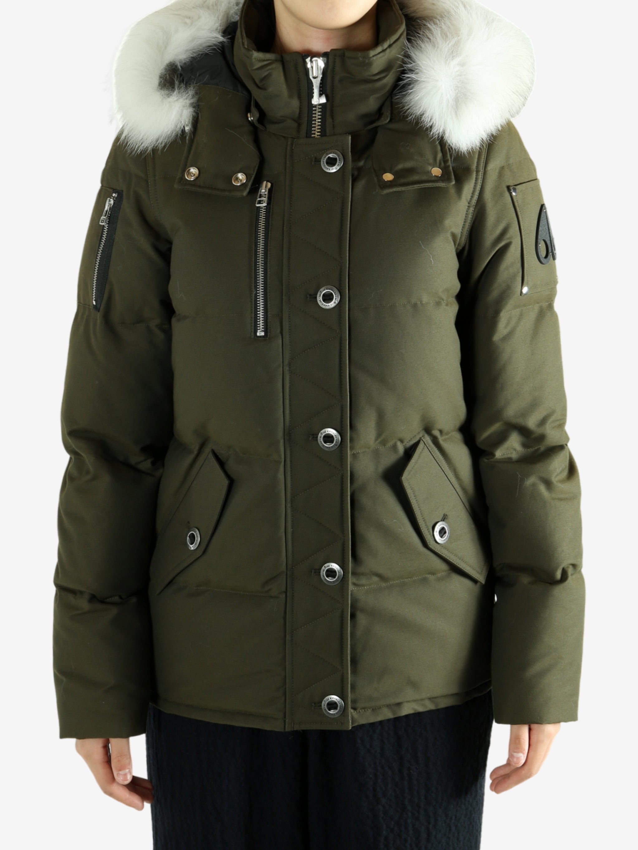 Green jackets worn by a person, showing the jackets fit