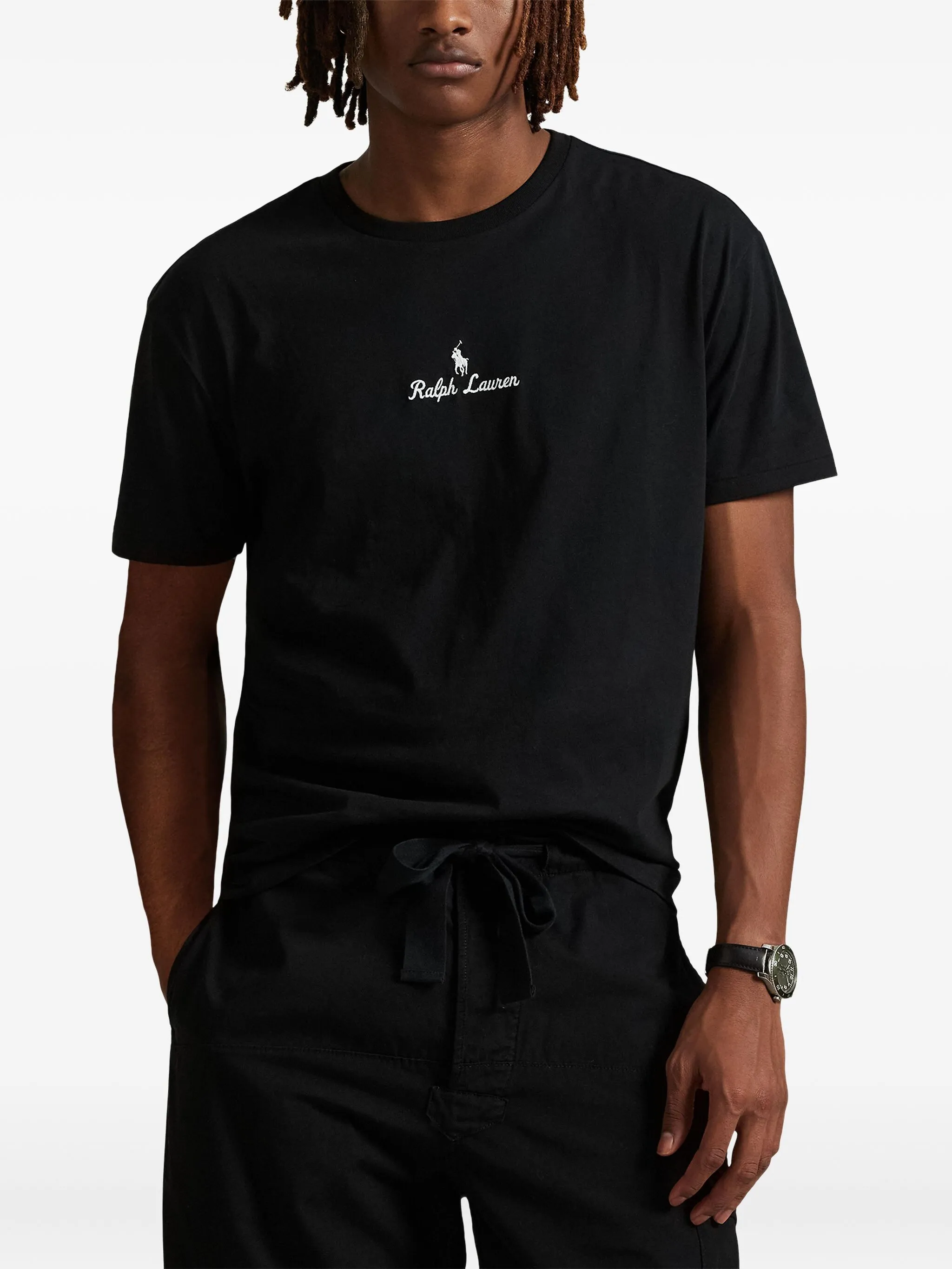 black t-shirt worn by a person, showing the t-shirt fit