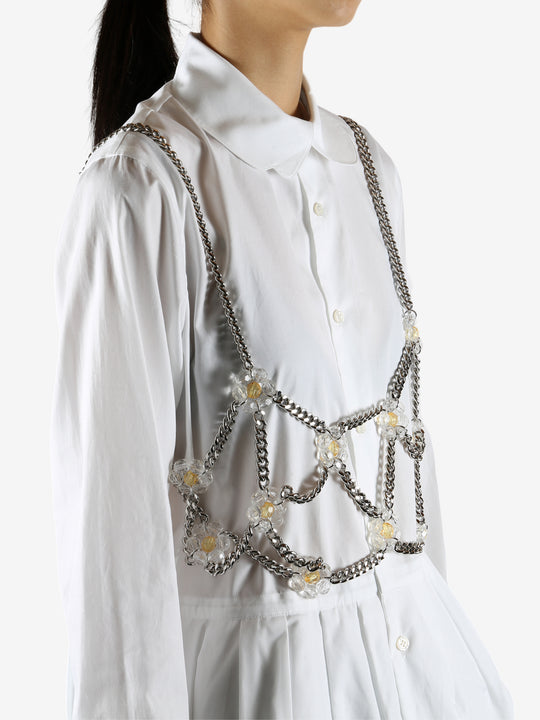 White top worn by a person, showing the top's fit