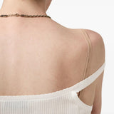 Close up of the white knitwear, showing texture of the cotton fabric