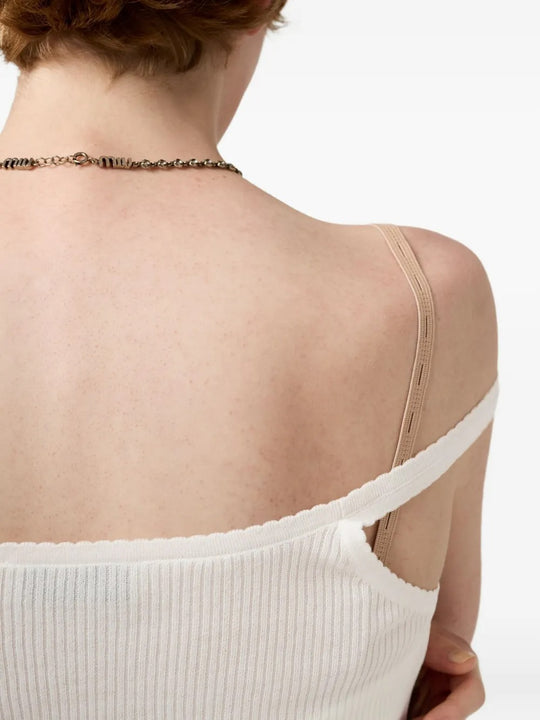 Close up of the white knitwear, showing texture of the cotton fabric