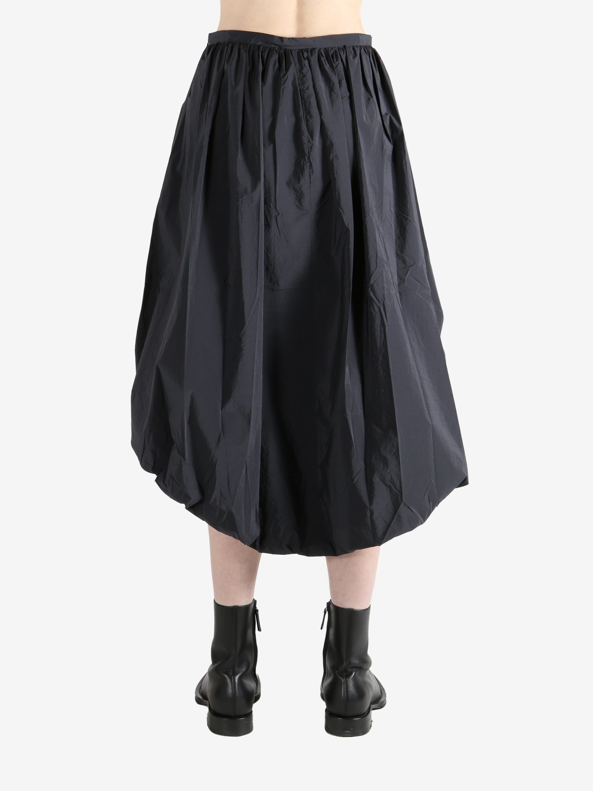 Grey skirts worn by a person, showing the skirts fit