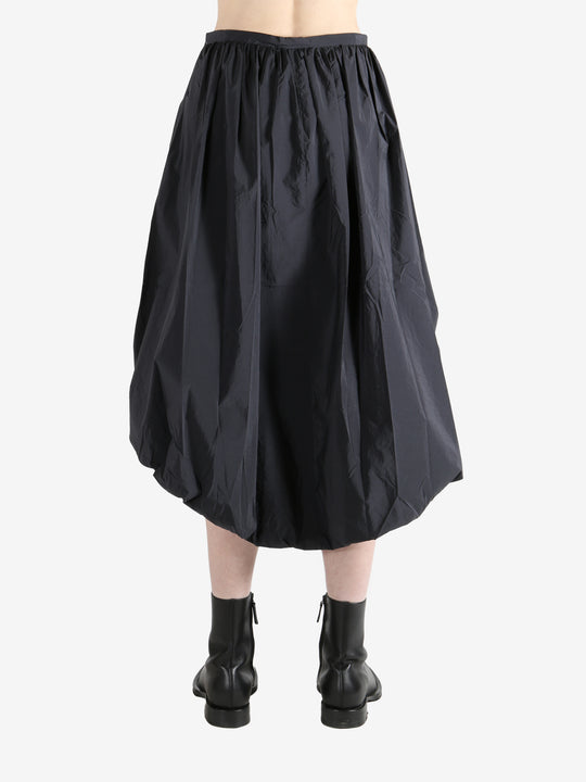 Grey skirts worn by a person, showing the skirts fit