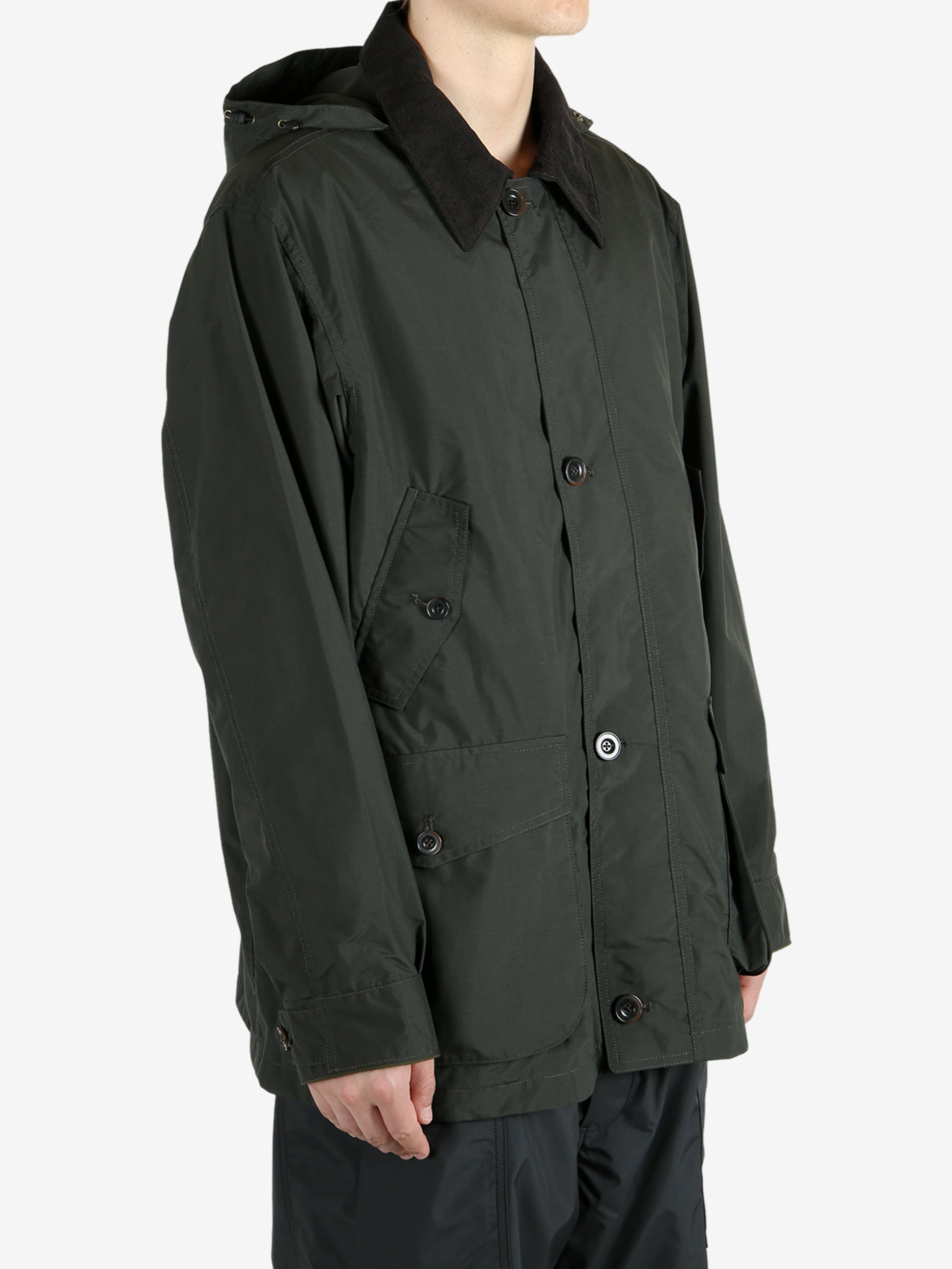 Green jackets worn by a person, showing the jacket’s fit