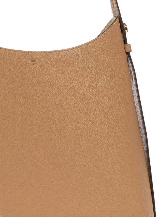 Close up of tan bag,showing texture of the leather fabric.