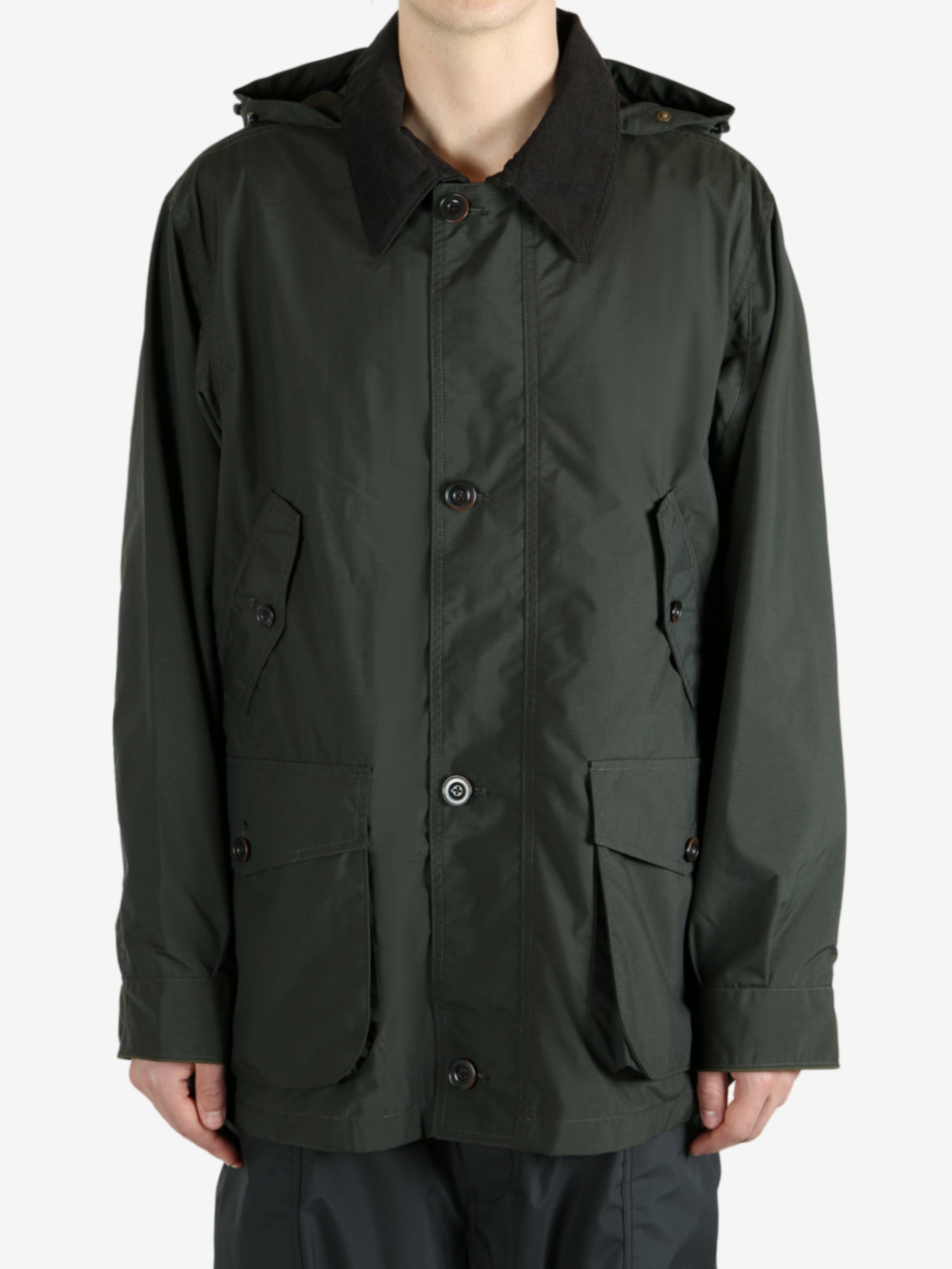 Green jackets worn by a person, showing the jacket’s fit