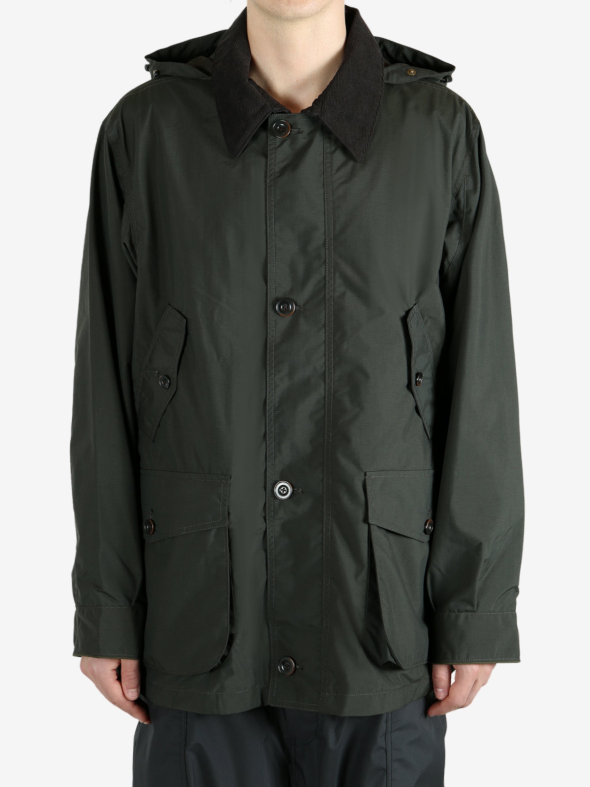 Green jackets worn by a person, showing the jacket’s fit