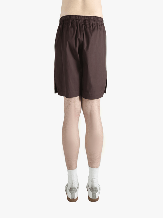 Brown shorts worn by a person, showing the shorts's fit