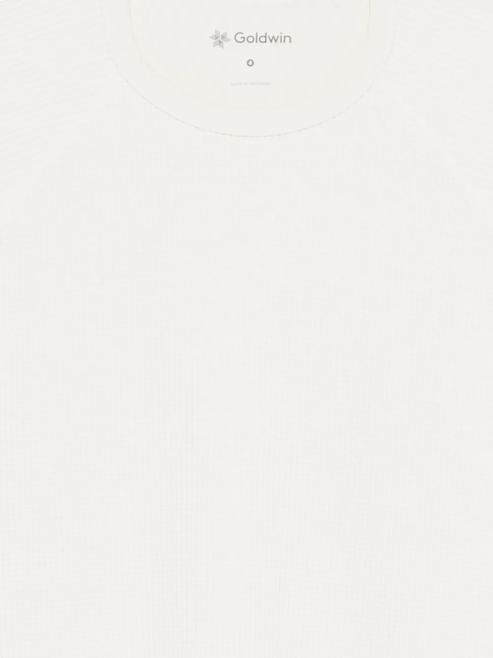 Close up of white t-shirt, showing texture of the Polyester and Elasterell-P fabric