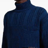 Close up of blue sweater, showing texture of the virgin wool fabric