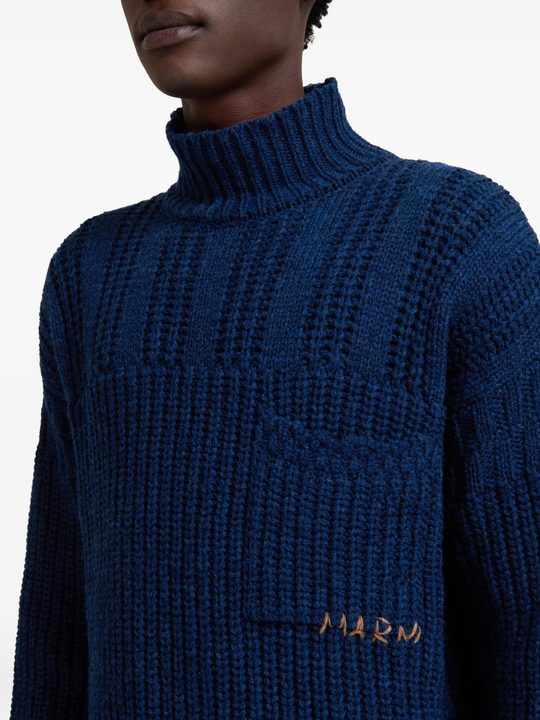Close up of blue sweater, showing texture of the virgin wool fabric
