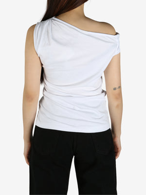 White top worn by a person, showing the top's fit