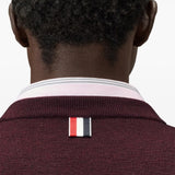 Burgundy knitwear worn by a person, showing the knitwear fit
