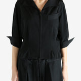 Black shirts worn by a person, showing the shirts fit