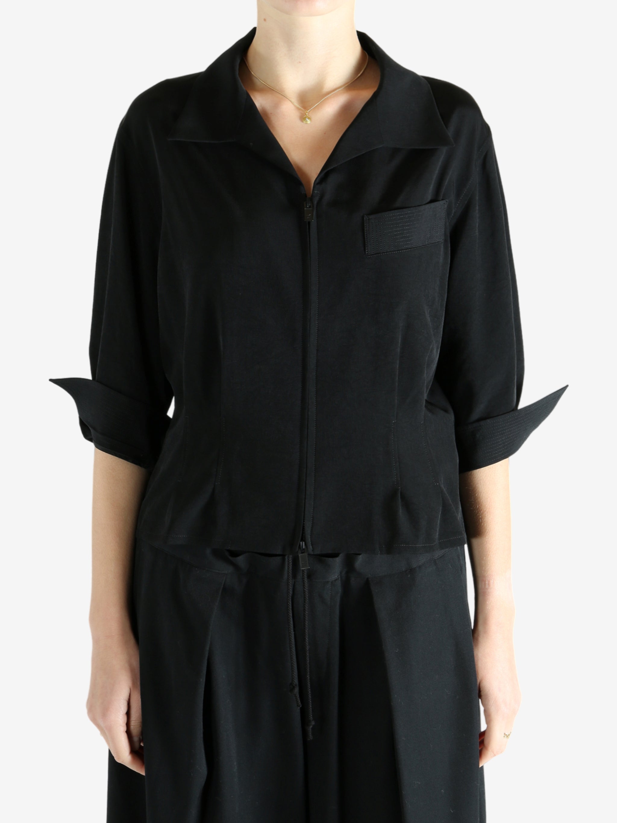 Black shirts worn by a person, showing the shirts fit