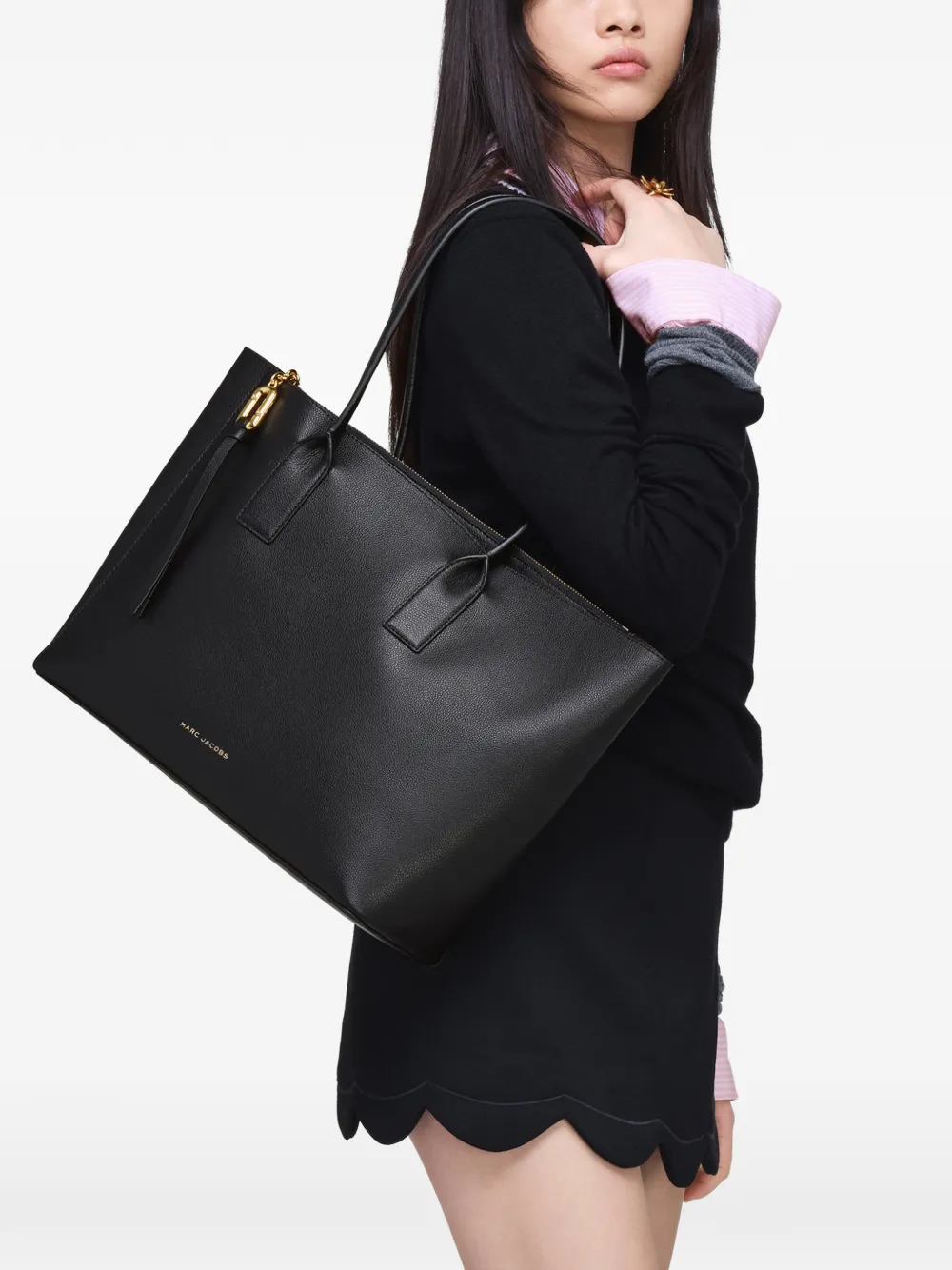 Black bag worn by a person, showing the black bag's fit