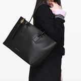 Black bag worn by a person, showing the black bag's fit