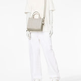 White bag worn by a person, showing the bag's fit