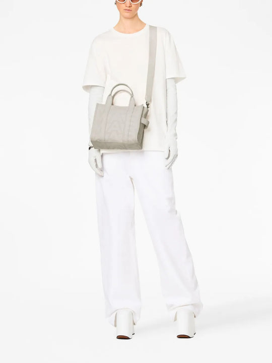 White bag worn by a person, showing the bag's fit