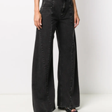 black pants worn by a person, showing the pants fit