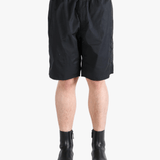 Black short worn by a person, showing the short's fit