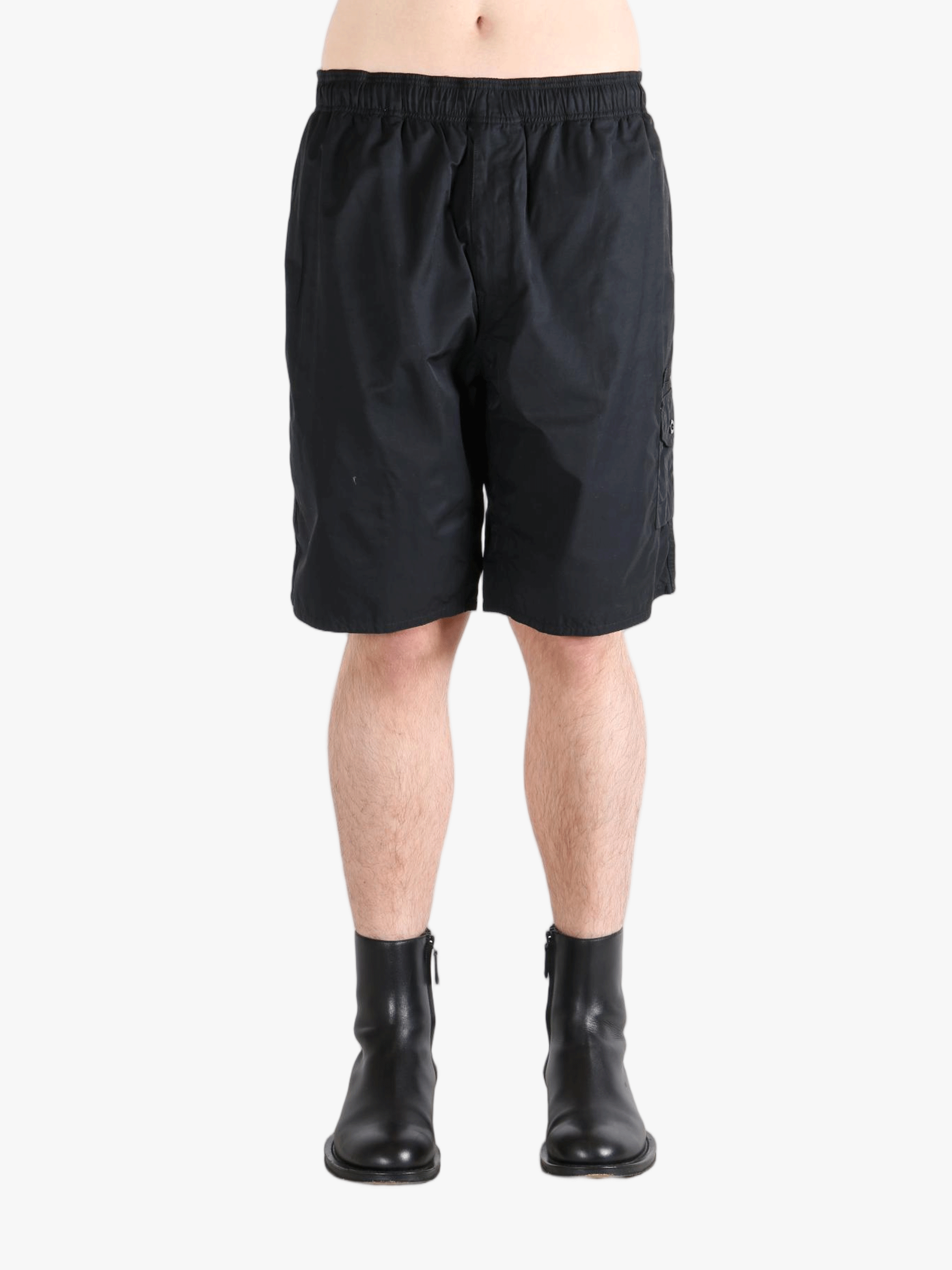 Black short worn by a person, showing the short's fit