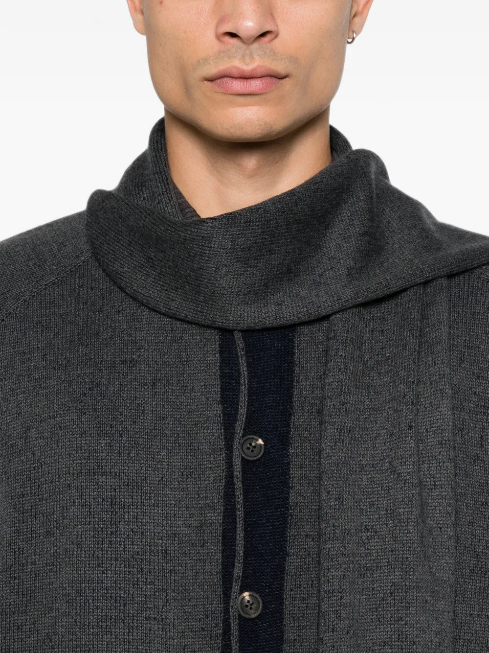 Grey knitwear worn by a person, showing the knitwear fit