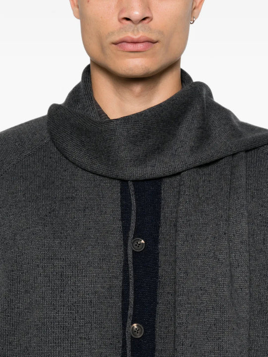 Grey knitwear worn by a person, showing the knitwear fit