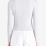 White knitwear worn by a person, showing the knitwear fit