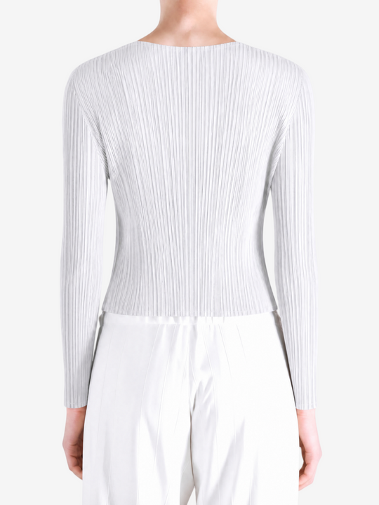 White knitwear worn by a person, showing the knitwear fit