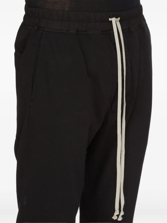 Black pants worn by a person, showing the pants fit