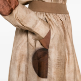 Close up of tan skirt, showing texture of the viscose fabric