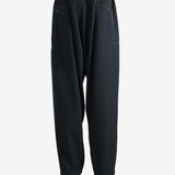 Black pants worn by a person, showing the pants' fit