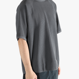 Gray shirt worn by a person, showing the shirt fit