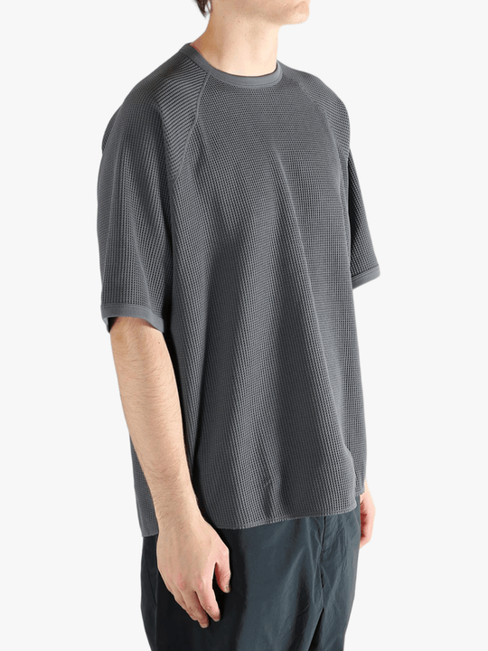 Gray shirt worn by a person, showing the shirt fit