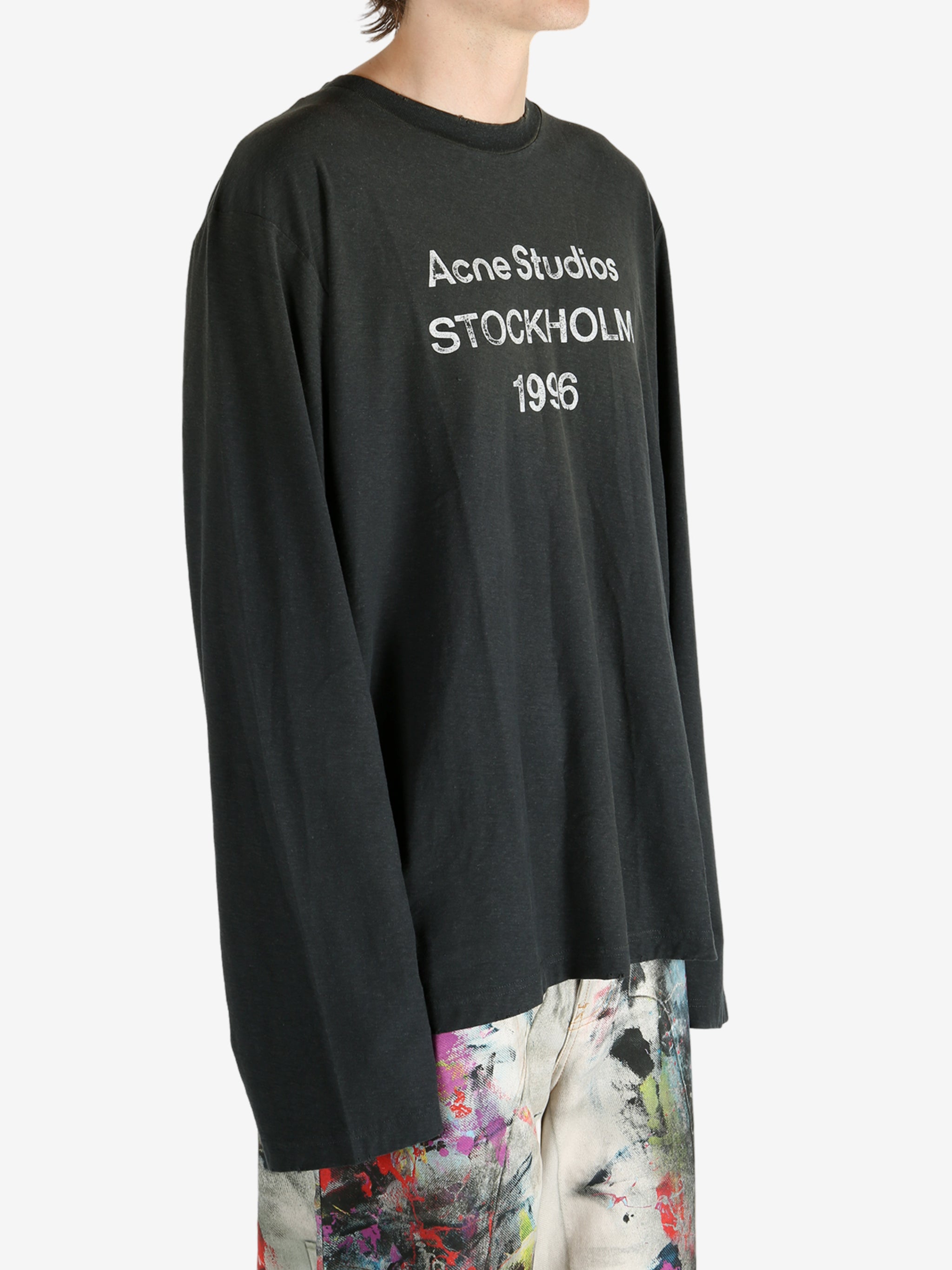 Black t-shirt worn by a person, showing the t-shirt's fit