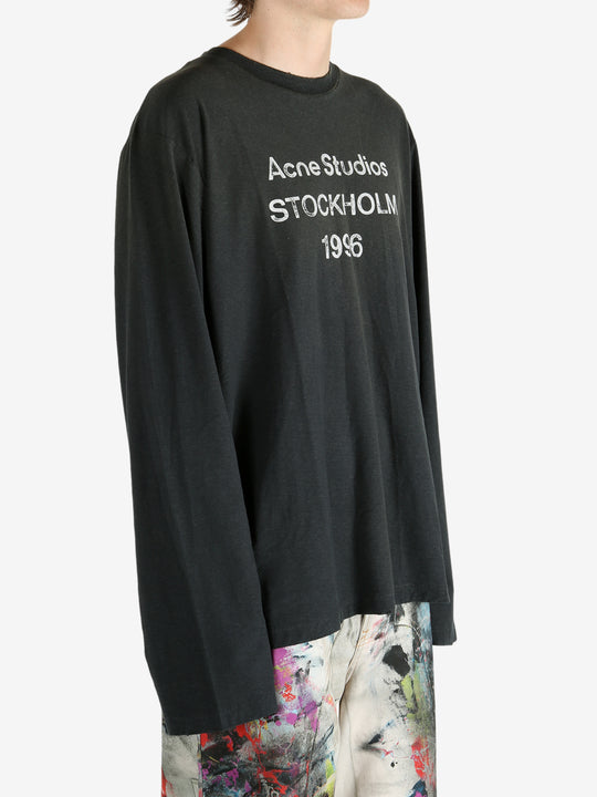 Black t-shirt worn by a person, showing the t-shirt's fit
