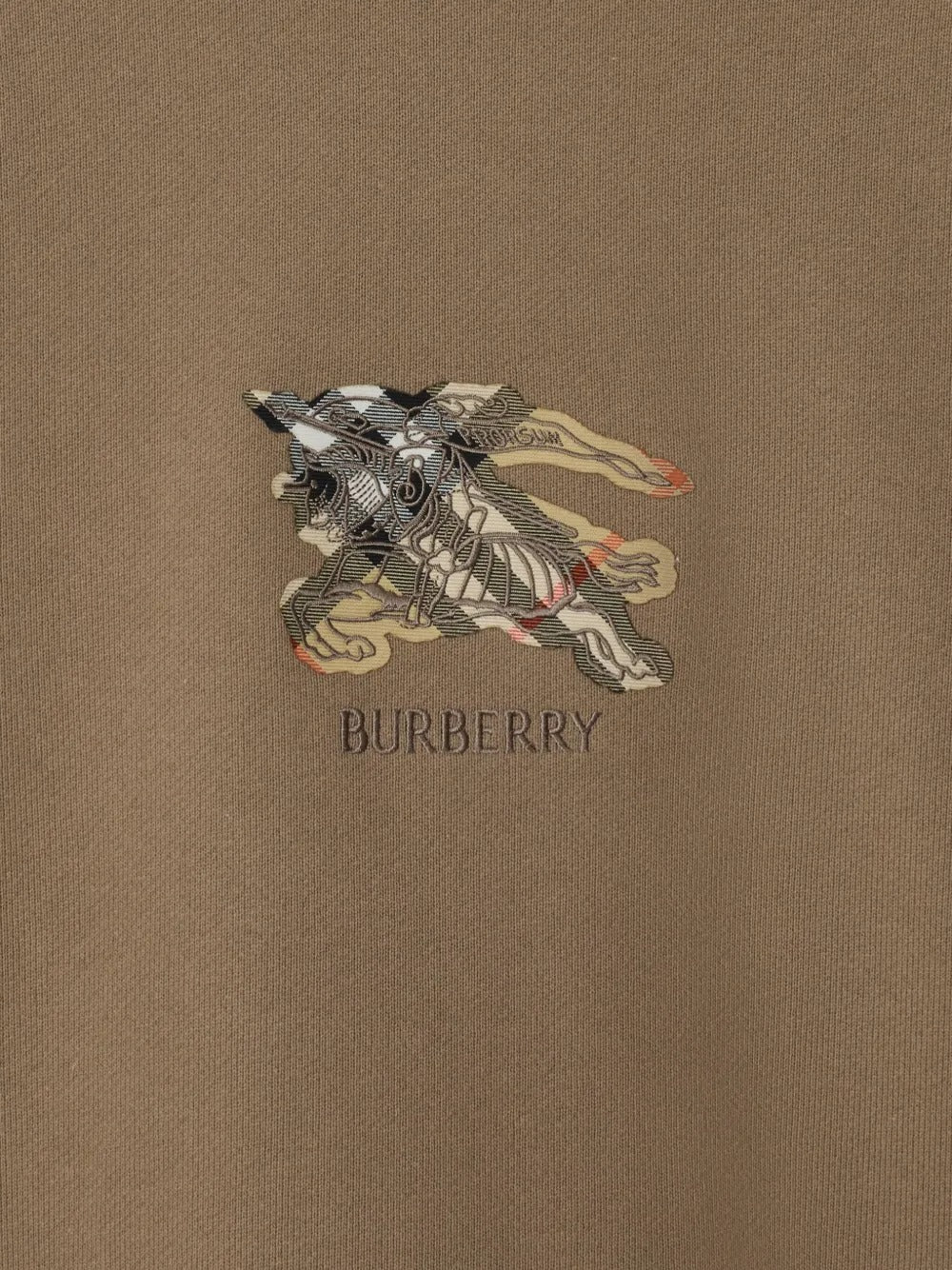 Close up of the brown shirt, showing texture of the cotton fabric