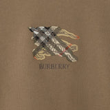 Close up of the brown shirt, showing texture of the cotton fabric